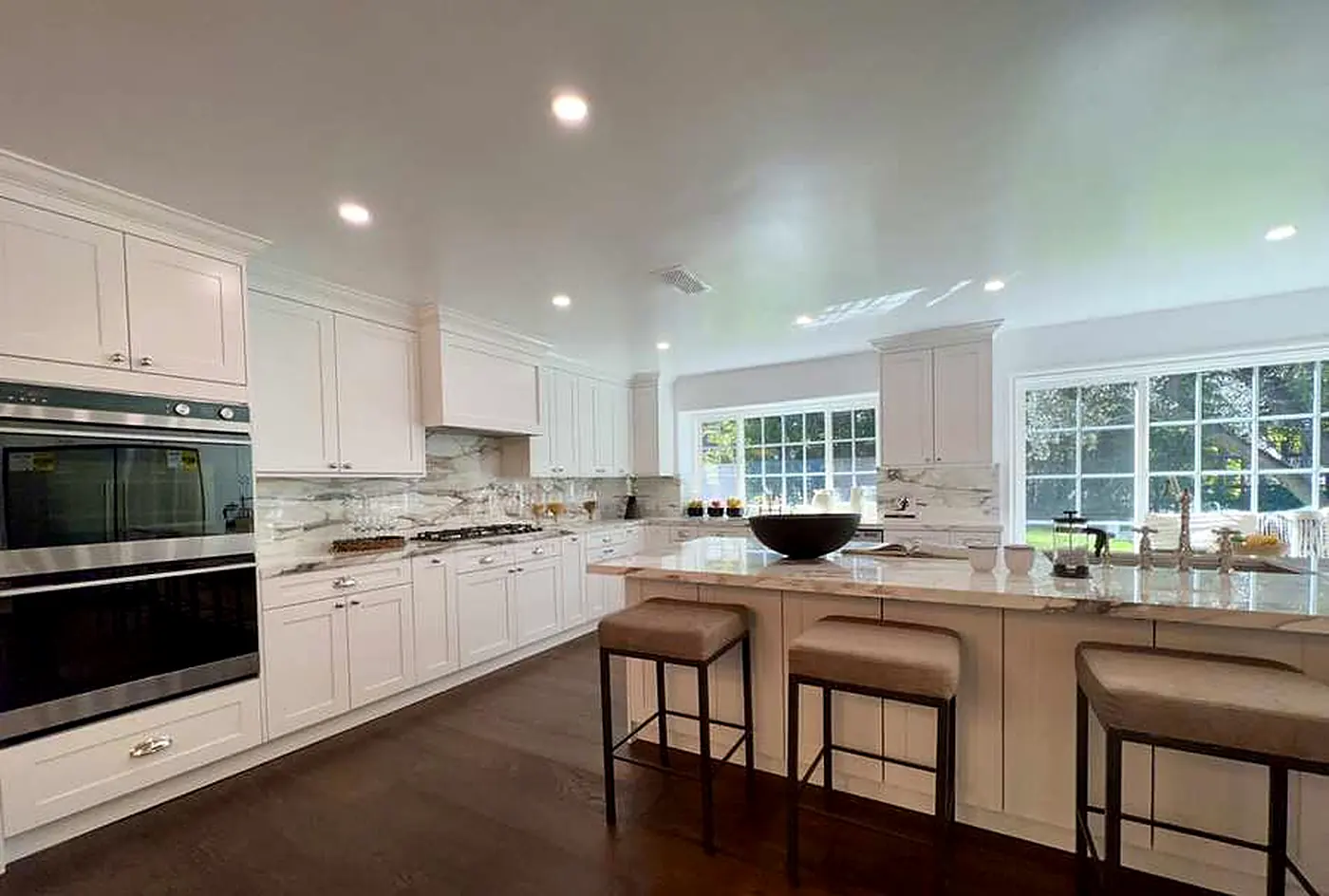 Remodeled white kitchen with island seating in Encino